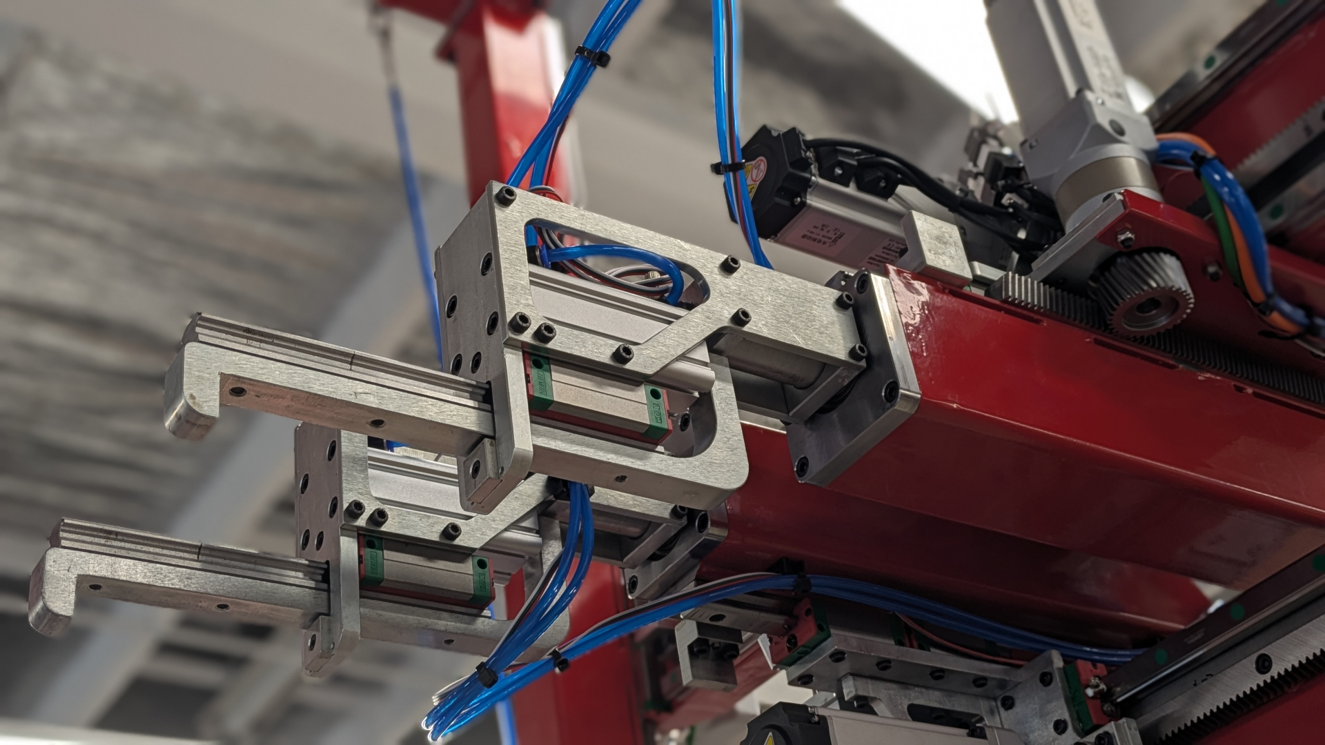 Close-up of a Stansted robotic assembly head with linear rails and pneumatic actuators